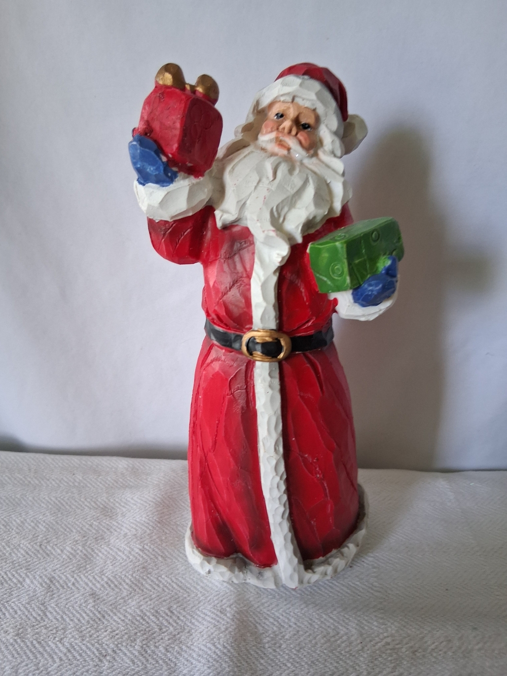 Festive Santa Figurine in Red Holding Gifts